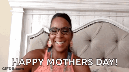 A Woman Is Laying In Bed With The Words Happy Mothers Day GIF