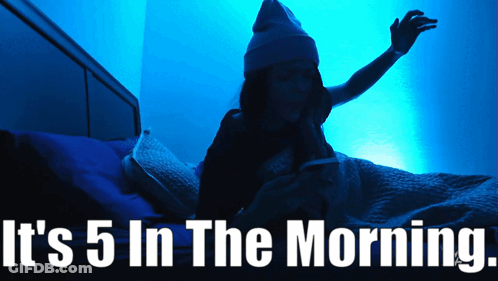 A Woman Is Laying In Bed With The Words It 'S 5 In The Morning GIF