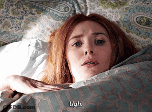 A Woman Is Laying In Bed With The Words Ugh On Her Face GIF