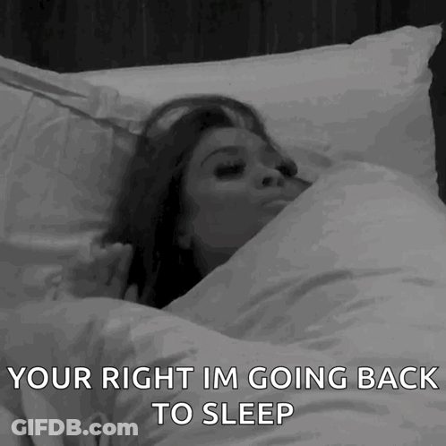 A Woman Is Laying In Bed With The Words " Your Right Im Going Back To Sleep " Above Her GIF