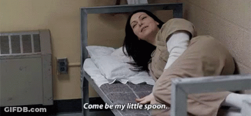 A Woman Is Laying On A Bed In A Prison Cell And Says `` Come Be My Little Spoon '' . GIF