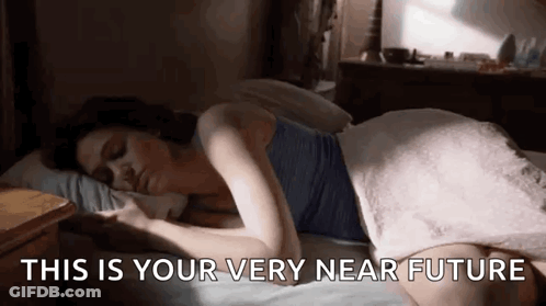 A Woman Is Laying On A Bed With The Words `` This Is Your Very Near Future '' Written On The Bottom . GIF