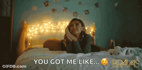 A Woman Is Laying On A Bed With The Words " You Got Me Like " Above Her GIF
