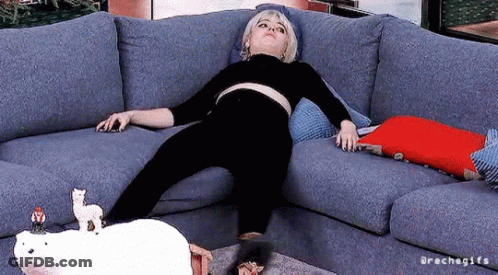 A Woman Is Laying On A Couch With A Stuffed Polar Bear On Top Of Her . GIF
