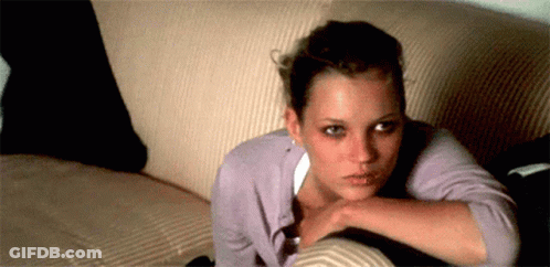 A Woman Is Laying On A Couch With Her Head Resting On Her Arm GIF