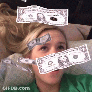 A Woman Is Laying On A Couch With Money Falling On Her Head GIF