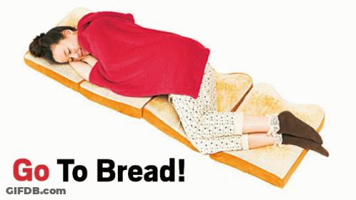 A Woman Is Laying On A Slice Of Bread With The Words Go To Bread Behind Her GIF