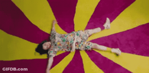 Woman Lying On Colorful Rug GIF