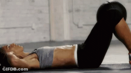 A Woman Is Laying On The Floor With Her Legs Crossed And A Reebok Top On GIF
