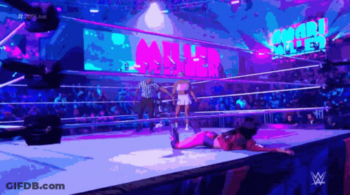 A Woman Is Laying On The Ground In A Wrestling Ring With The Word Miller Behind Her GIF