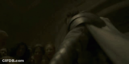 A Woman Is Laying On The Ground With A Knife In Her Hand And A Light Shining On Her Face . GIF