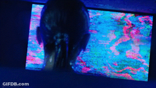 A Woman Is Looking At A Colorful Screen With The Words Gifsaespa On The Bottom Right GIF