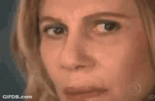 A Woman Is Looking At A Triangle With A Mathematical Equation Written On It . GIF