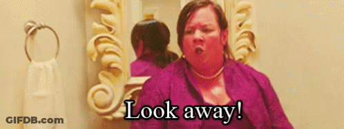 A Woman Is Looking At Herself In A Bathroom Mirror And Says `` Look Away '' . GIF