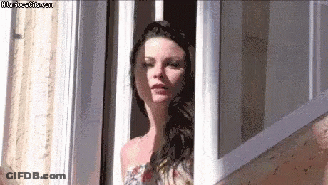 A Woman Is Looking Out Of A Window With Hilariousgifs.com Written On The Bottom GIF