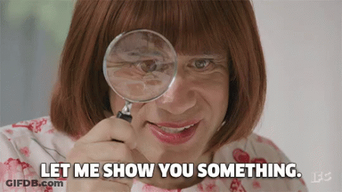 A Woman Is Looking Through A Magnifying Glass And Says Let Me Show You Something GIF