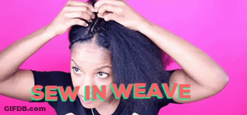 A Woman Is Making A Braid In Her Hair . GIF