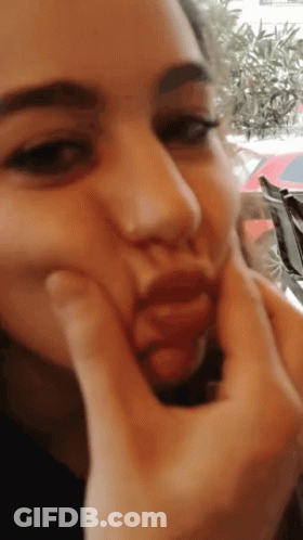 A Woman Is Making A Face With Her Hands GIF