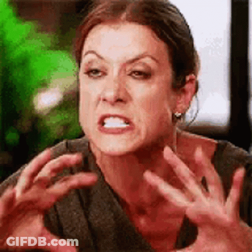 A Woman Is Making A Funny Face And Making A Funny Face With Her Hands . GIF
