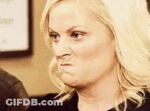 A Woman Is Making A Funny Face And Making A Funny Face With Her Mouth Open . GIF
