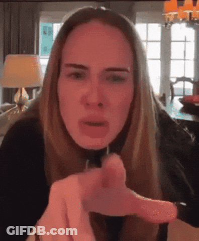A Woman Is Making A Funny Face And Pointing At The Camera GIF