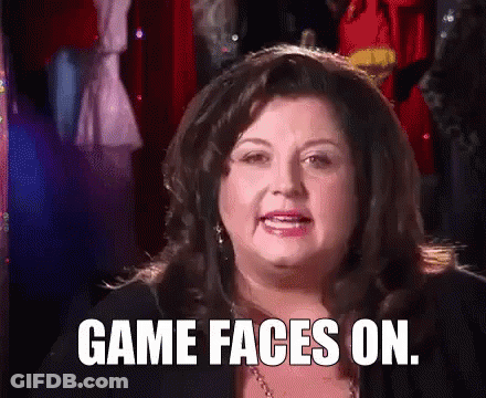 A Woman Is Making A Funny Face And Saying `` Game Faces On '' . GIF