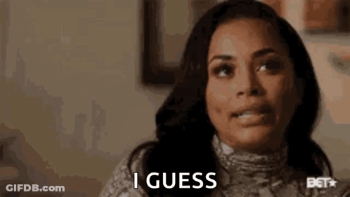 A Woman Is Making A Funny Face And Saying `` I Guess '' While Sitting At A Table . GIF