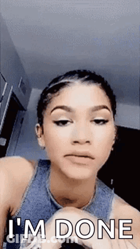 A Woman Is Making A Funny Face And Saying `` I 'M Done '' While Looking At The Camera . GIF