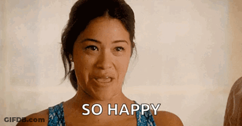 A Woman Is Making A Funny Face And Smiling While Saying `` So Happy '' . GIF