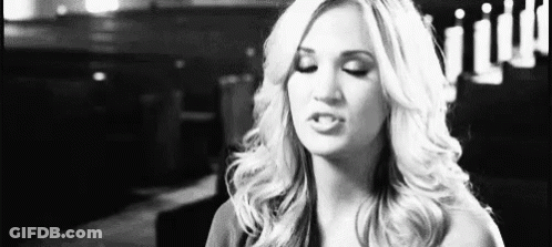 A Woman Is Making A Funny Face In A Black And White Photo . GIF