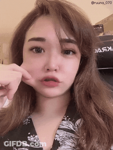 A Woman Is Making A Funny Face In Front Of A Poster That Says " Dark " GIF