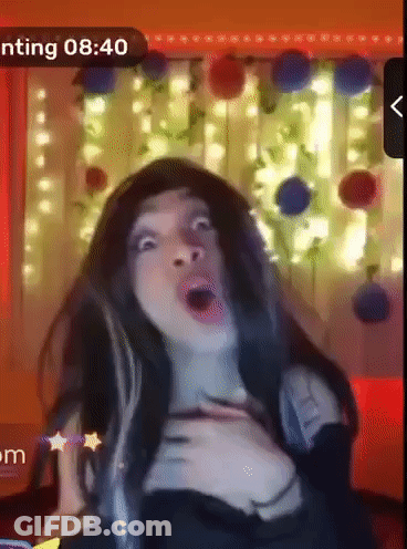 A Woman Is Making A Funny Face In Front Of A Screen That Says ' Nting 8:40 ' GIF