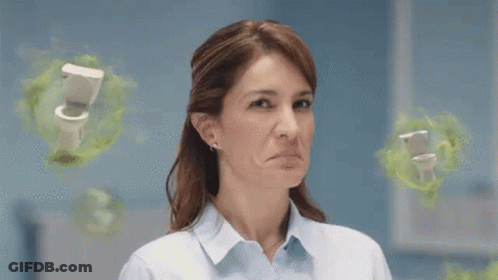 A Woman Is Making A Funny Face In Front Of A Toilet . GIF