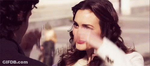 A Woman Is Making A Funny Face While A Man Is Taking A Picture Of Her . GIF