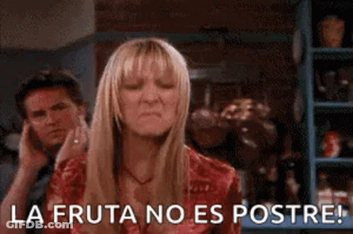 A Woman Is Making A Funny Face While A Man Talks On A Cell Phone In The Background . GIF