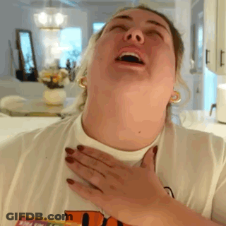A Woman Is Making A Funny Face While Holding Her Chest . GIF