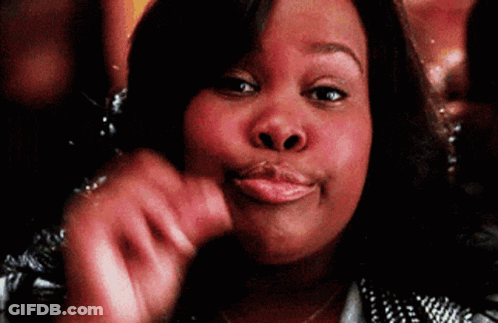 A Woman Is Making A Funny Face While Holding Her Hand To Her Face . GIF