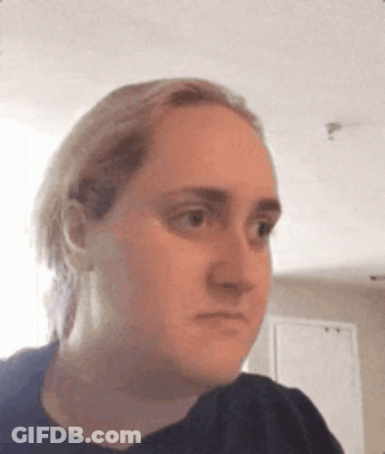 A Woman Is Making A Funny Face While Looking At The Camera . GIF