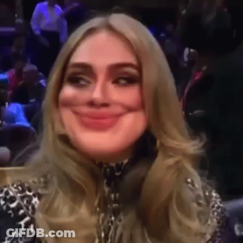 A Woman Is Making A Funny Face While Sitting In A Stadium . GIF