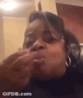 A Woman Is Making A Funny Face While Sitting On A Couch In A Room . GIF