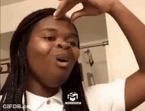 A Woman Is Making A Funny Face While Touching Her Nose . GIF