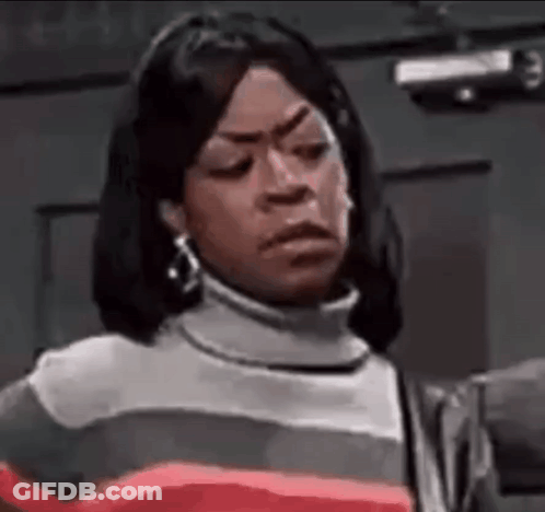 A Woman Is Making A Funny Face While Wearing A Striped Sweater And Earrings . GIF