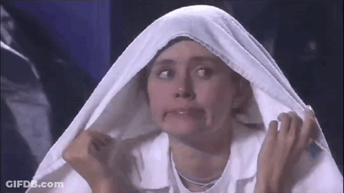 A Woman Is Making A Funny Face While Wearing A White Cloth Over Her Head GIF