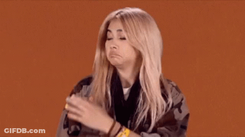 A Woman Is Making A Funny Face While Wearing A Wristband That Says ' A ' On It GIF
