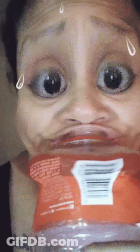 A Woman Is Making A Funny Face With A Bag Of Chips GIF