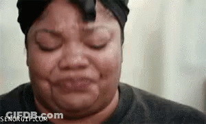 A Woman Is Making A Funny Face With Her Eyes Closed GIF