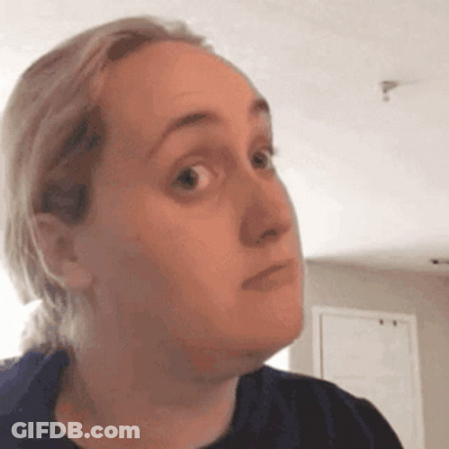 A Woman Is Making A Funny Face With Her Eyes Closed . GIF