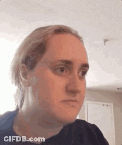 A Woman Is Making A Funny Face With Her Eyes Closed . GIF
