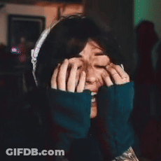 A Woman Is Making A Funny Face With Her Hands On Her Face . GIF