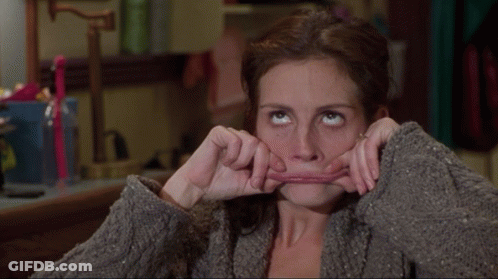 A Woman Is Making A Funny Face With Her Mouth GIF